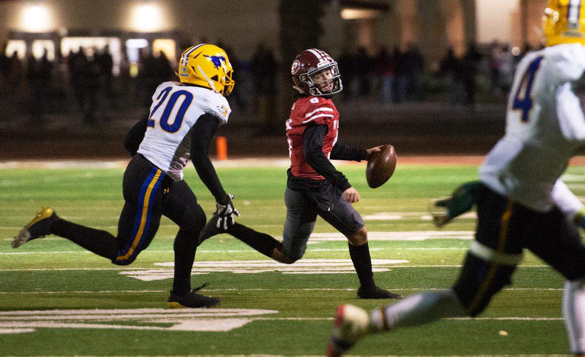 Grant’s Hakim Reynold chases Patterson quarterback Max Medina during the Sac-Joaquin Section Division III semifinal in Patterson, Calif., Friday, Nov. 18, 2022. Grant won 80-44.