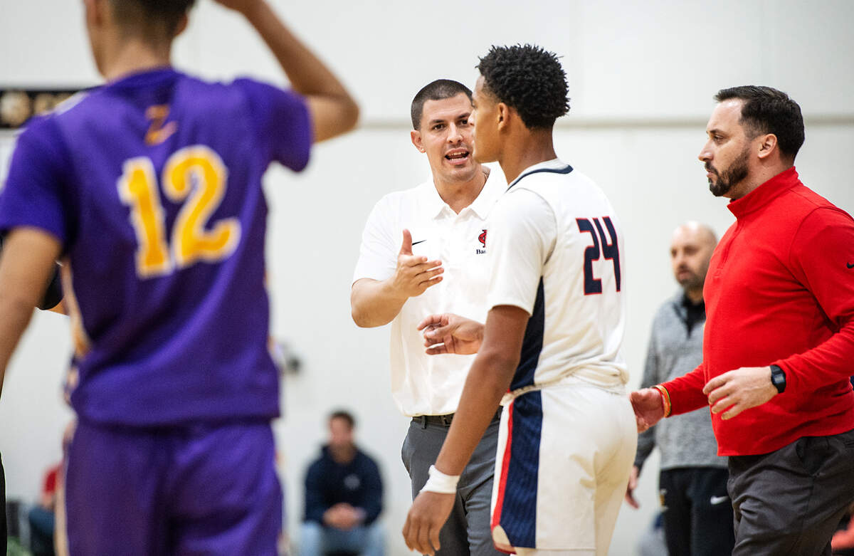 Modesto Christian coach Brice Fantazia talks with Jamari Phillips during the Holiday Hoops Classic championship game with Durango NV in Salida, Calif., on Thursday, Dec. 30, 2021.