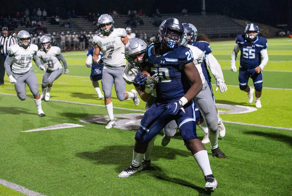 Granite Bay defenders stop the run by Downey’s Ki Ragland during the CIF Sac-Joaquin Section Division II playoff game at Downey High School in Modesto, Calif., Friday, Nov.11, 2022.