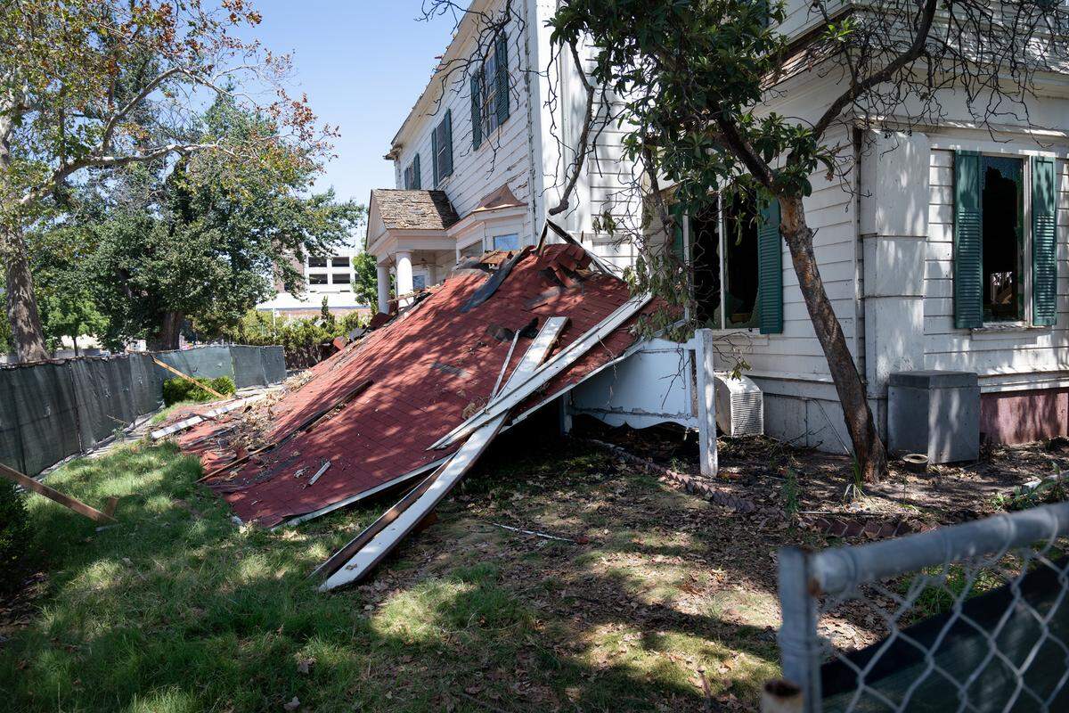Former Franklin Downs funeral home has been fenced up after a fire damaged the 1885 era building on July 16. Photographed in Modesto, Calif., Tuesday, July 23, 2024.