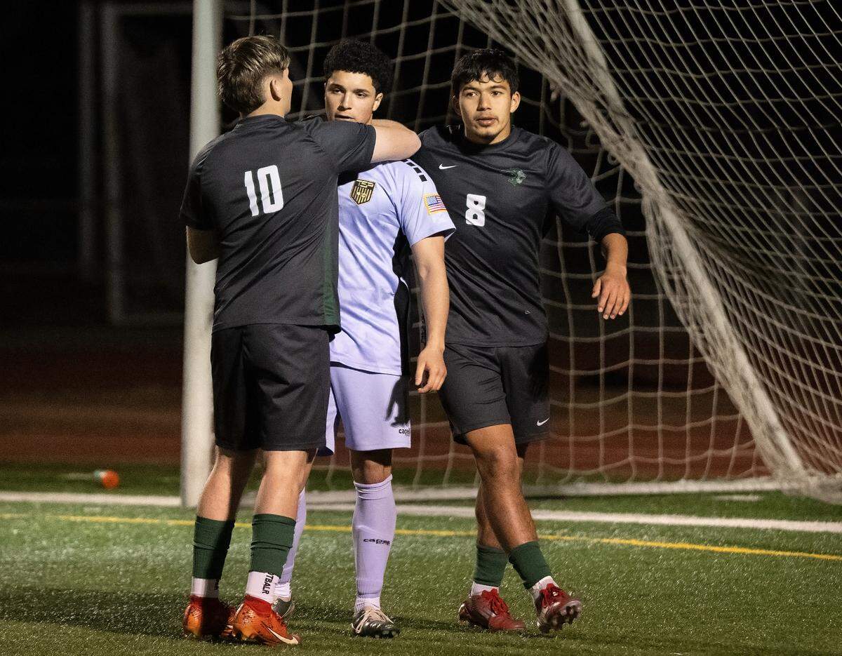 Pitman’s Anthony Zaragoza (10) and Davian Lizarraga (8) console goalkeeper Isaac Padilla after the penalty kick loss to Cardinal Newman in the CIF NorCal Division II regional semifinal playoff match at Turlock High School in Turlock, Thursday, March, 6, 2025.