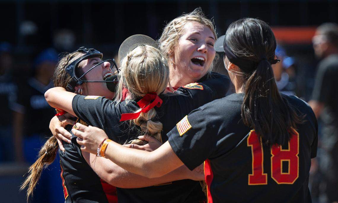 Oakdale players embrace after winning the Sac-Joaquin Section D III softball championship game over Capital Christian at Cosumnes River College in Sacramento, Calif., Saturday, May 25, 2024.