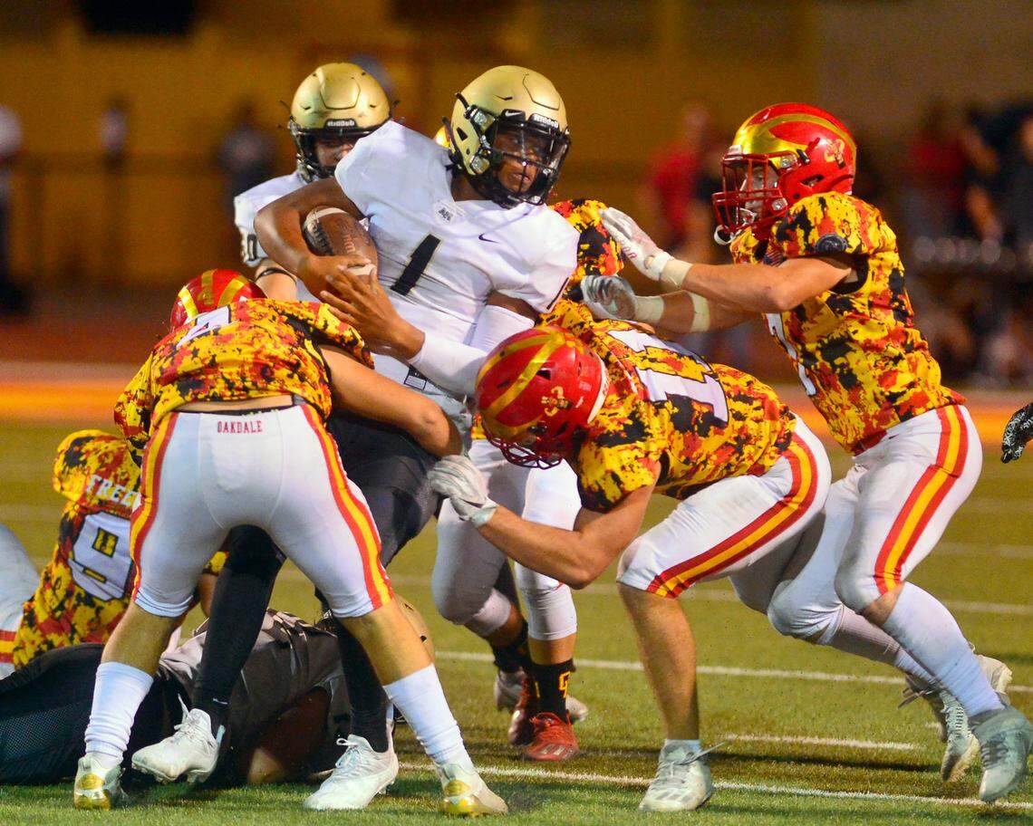 Archbishop Mitty quarterback Wills Towers gets taken down by multiple Oakdale defenders during a football game between Oakdale High School and Archbishop Mitty High School at Oakdale High School in Oakdale California on September 10, 2021.