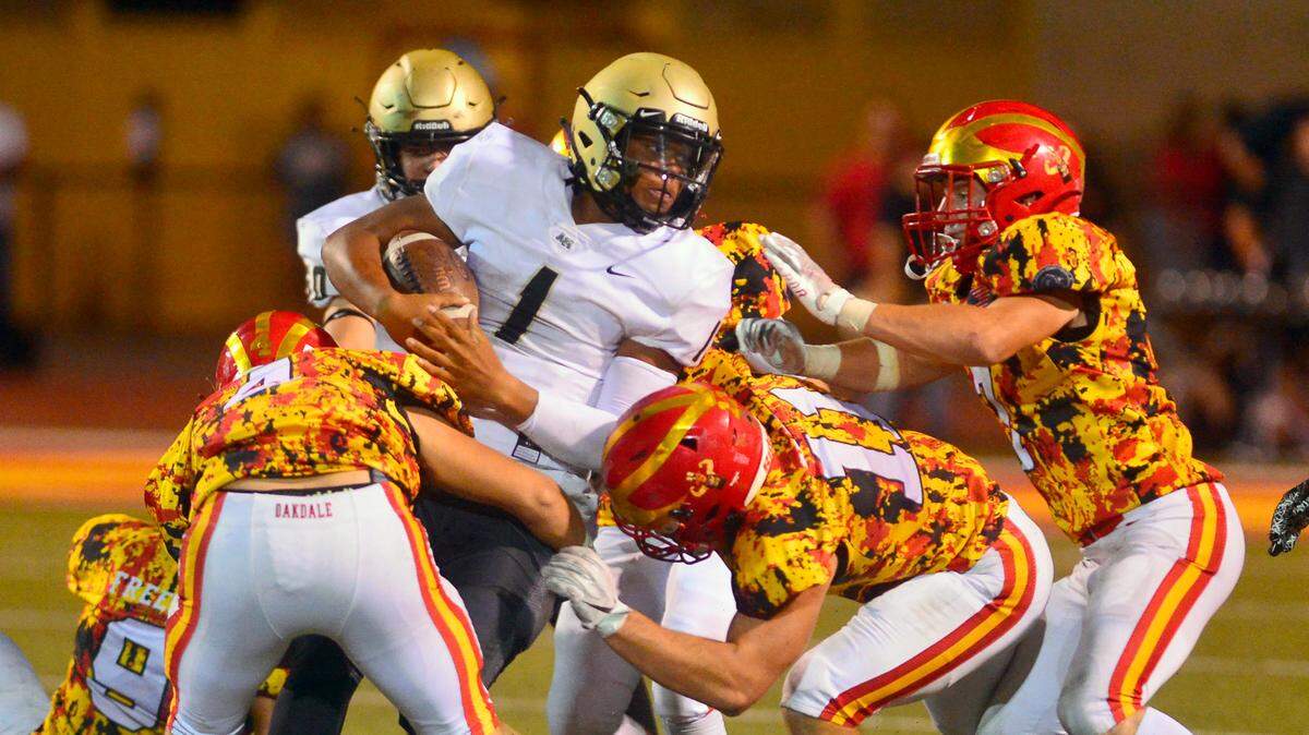 Archbishop Mitty quarterback Wills Towers gets taken down by multiple Oakdale defenders during a football game between Oakdale High School and Archbishop Mitty High School at Oakdale High School in Oakdale California on September 10, 2021.