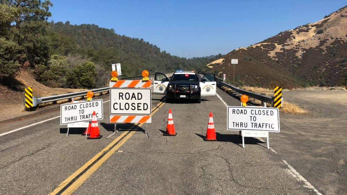 A roadblock on Parrotts Ferry Road for the Airola fire on Wednesday, Aug. 25.