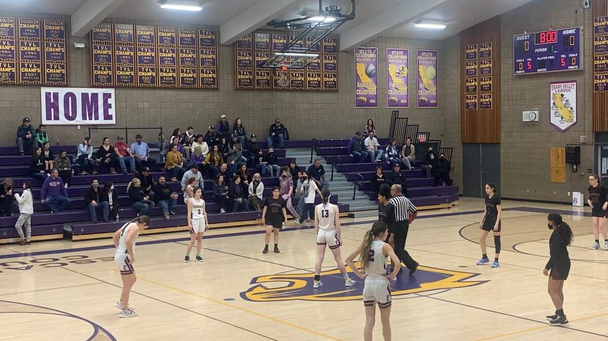 Escalon and Riverbank meet at center court for the tip off of their Trans-Valley League game on Jan. 25, 2021. The Cougars won 34-32.