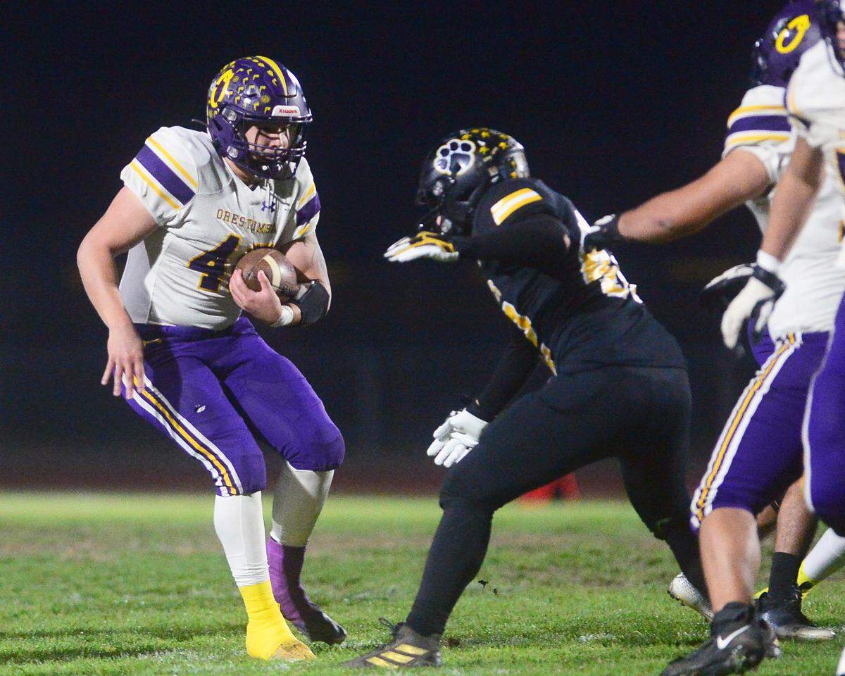 Orestimba running back Kai Brazil braces for a hit from a Hughson defender during a Sac-Joaquin Section Division VI playoff game in Hughson, California, on Nov. 18, 2022. Hughson won 21-17.