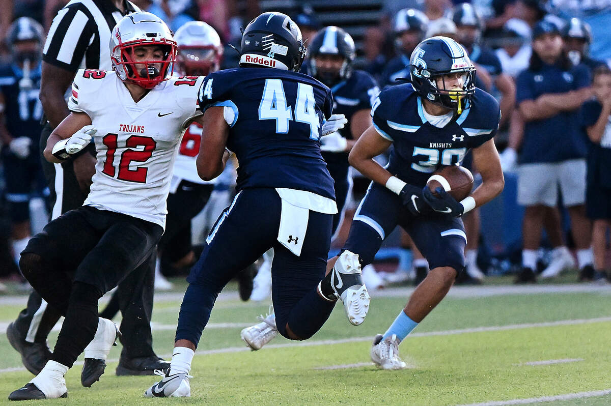 Downey’s Noah Cruz intercepts a pass during the season opening game with Lincoln at Downey High School in Modesto, Calif., Friday, August 18, 2023.
