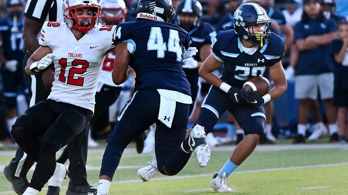 Downey’s Noah Cruz intercepts a pass during the season opening game with Lincoln at Downey High School in Modesto, Calif., Friday, August 18, 2023.