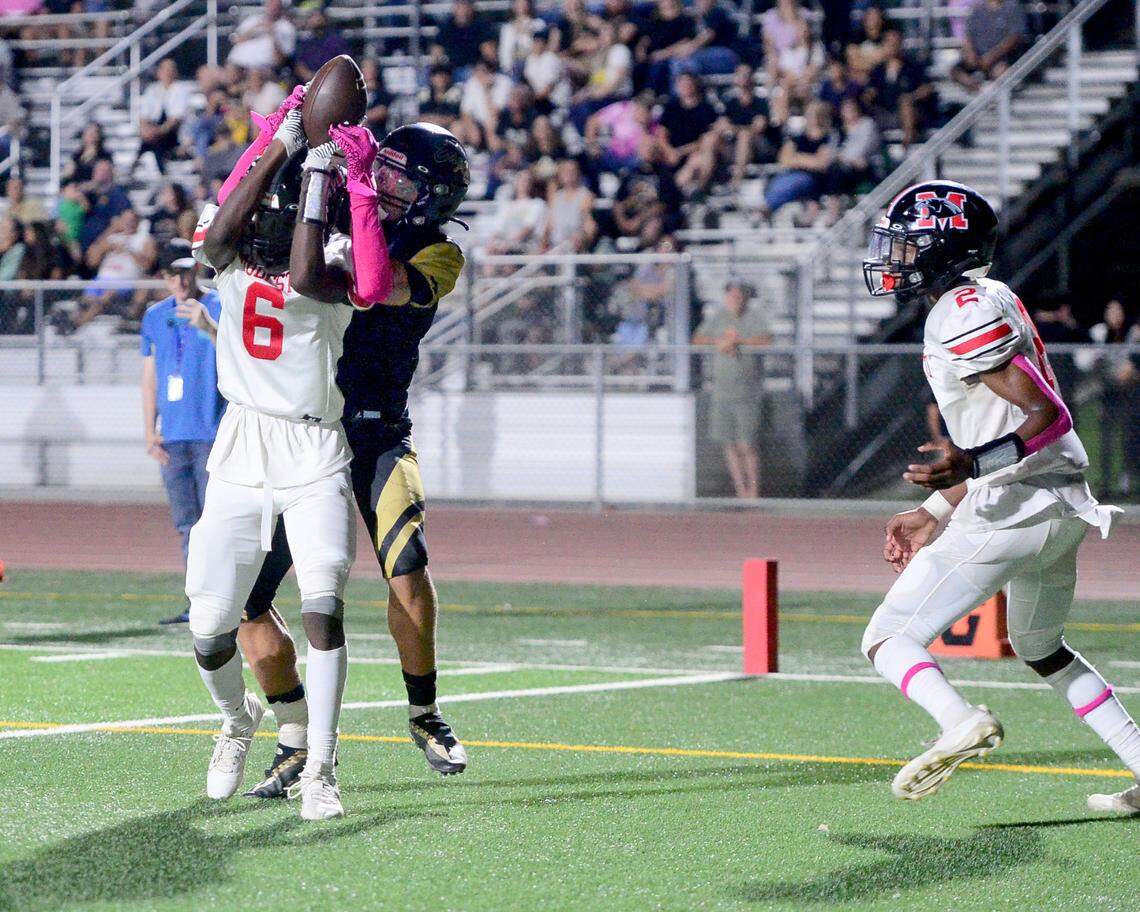 Modesto defensive back Jamal Lea (6) pulls the ball away from Enochs receiver Isaiah Maxey (4) during a game between Modesto High School and Enochs High School at Gregori High School in Modesto, CA on October 4, 2024.