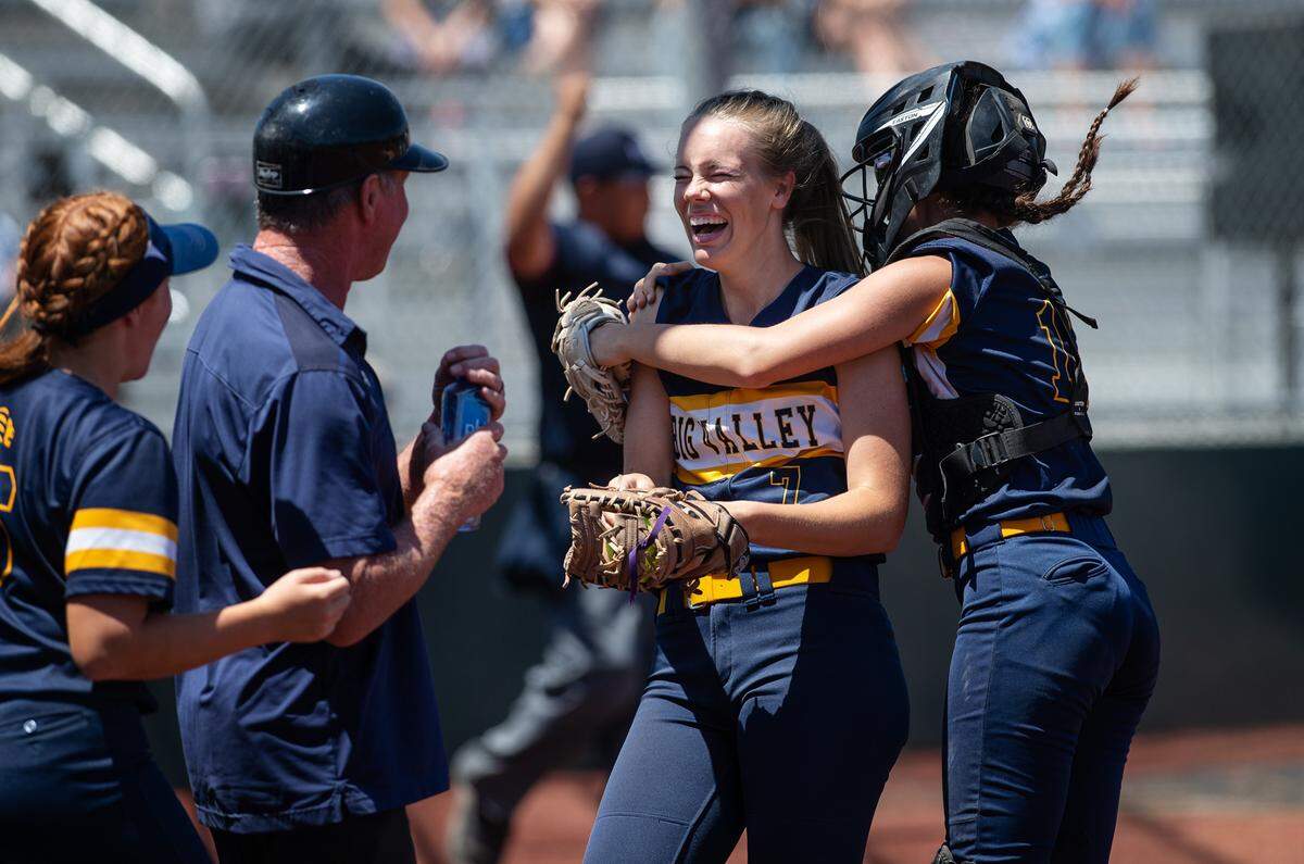 Big Valley Christian’s Trinity Beers is hugged by catcher Emily Avila after making a catch on a foul ball during the Sac-Joaquin Section Softball Division VII championship game with Stone Ridge Christian at Delta College in Stockton, Calif., on Saturday, May 21, 2022.