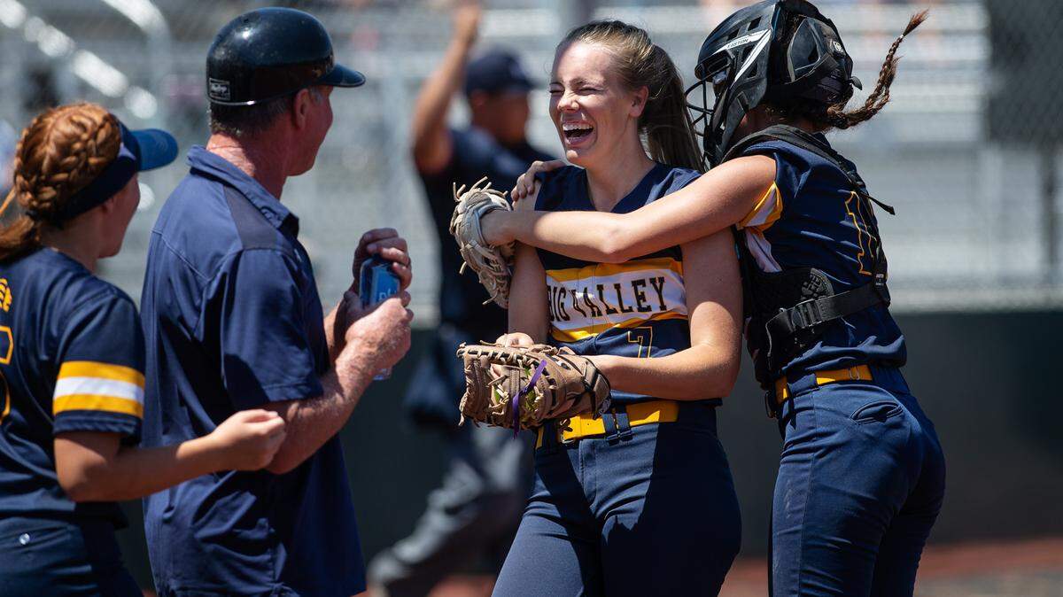 Big Valley Christian’s Trinity Beers is hugged by catcher Emily Avila after making a catch on a foul ball during the Sac-Joaquin Section Softball Division VII championship game with Stone Ridge Christian at Delta College in Stockton, Calif., on Saturday, May 21, 2022.