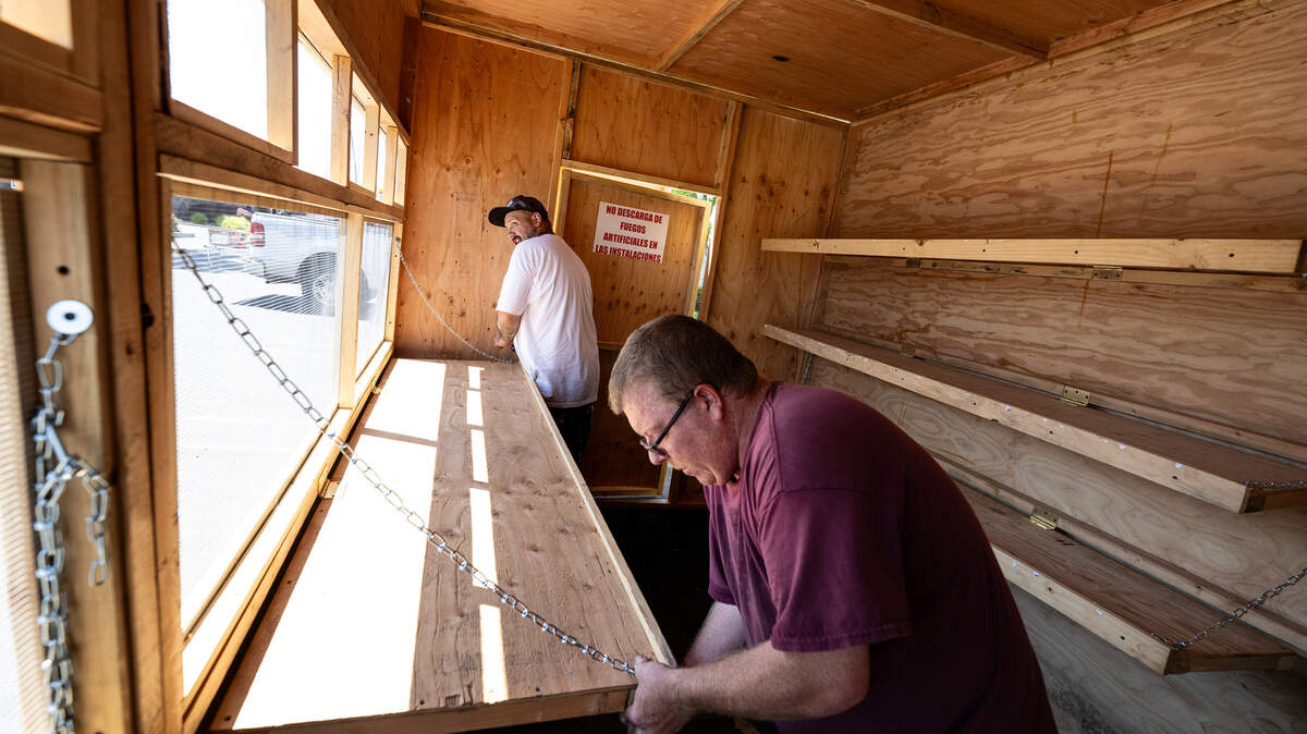 James Warner, right, and Sean Vernon, left, finish assembling a fireworks stand at 1800 Oakdale Road in Modesto, Calif., Wednesday, June 21, 2023. Local nonprofit Knights of Columbus will sell fireworks out of the stand on Oakdale Road.