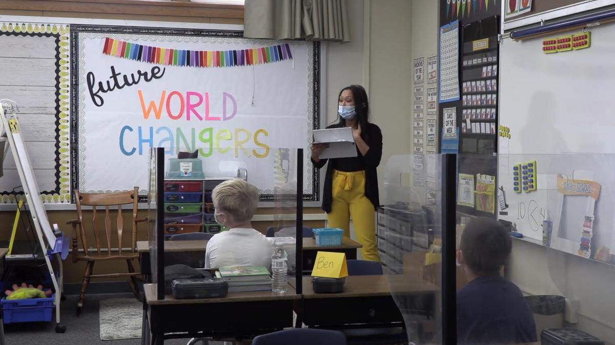In this still from a Modesto City Schools training video, a teacher shows how she uses her detachable laptop’s camera as she moves around the classroom.