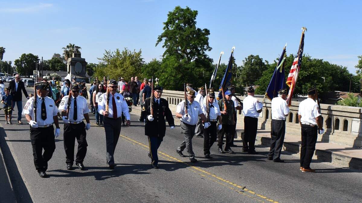 Members of Veterans of Foreign Wars Post 74 and American Legion Post 3199 march onto the Seventh Street bridge across the Tuolumne River in Modesto for a Memorial Day commemoration on Monday, May 29, 2023.