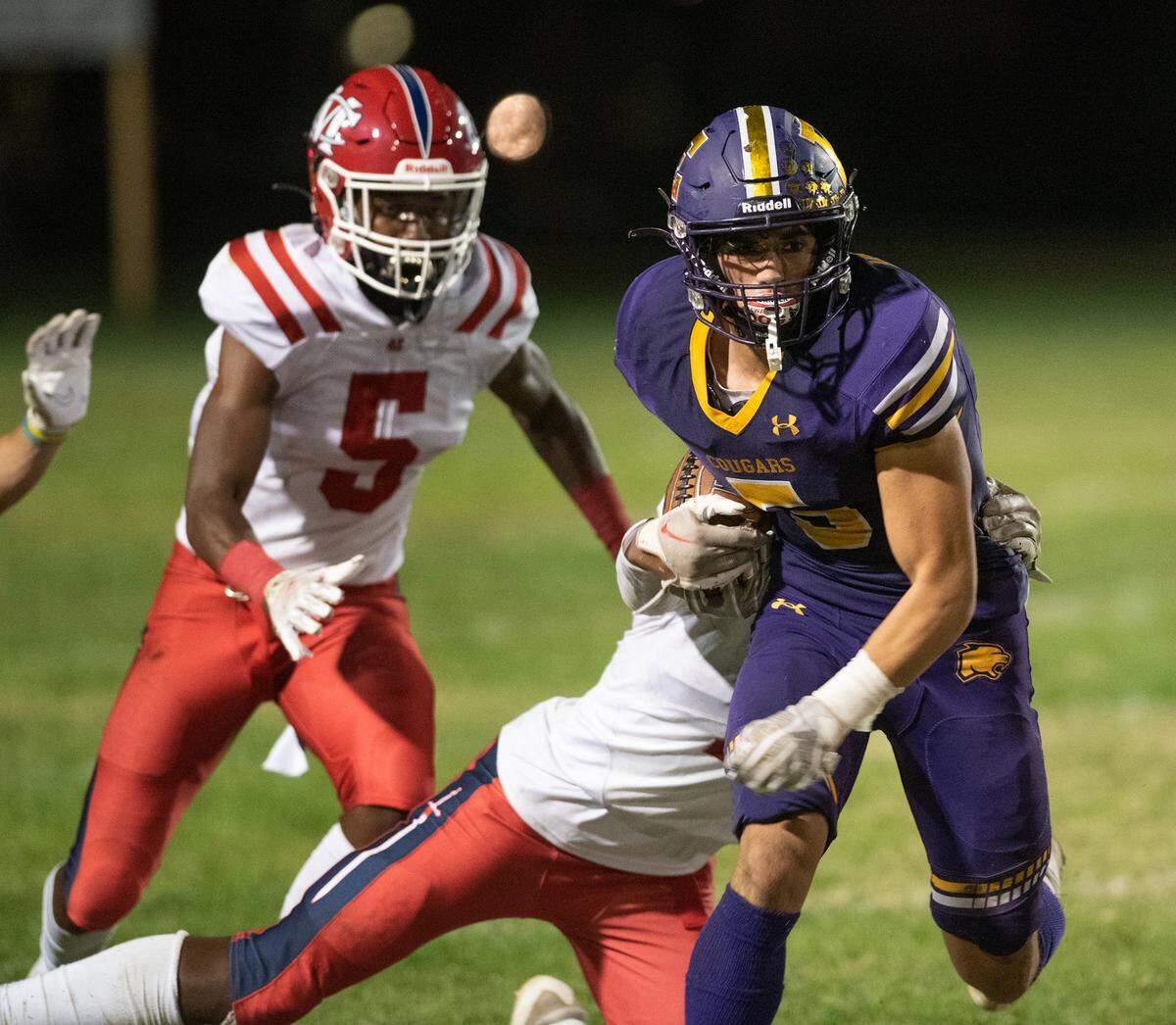 Escalon’s Logan Anderson runs trough the tackling of Modesto Christian’s Jeremiah Bernard during the Trans-Valley League game in Escalon, Calif., Thursday, Oct. 6, 2022. Escalon won the game 62-30.