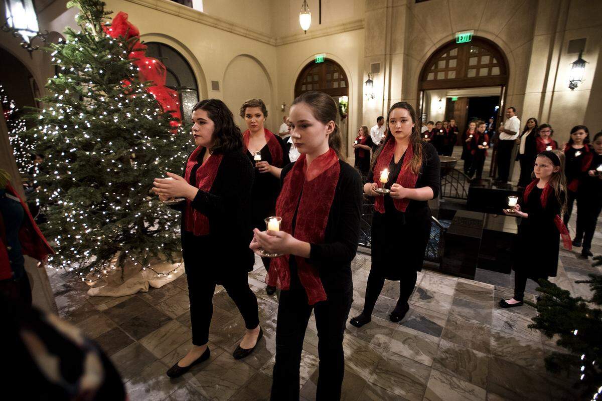 Mary Frey, middle, and Caroline Fletcher, left, lead members of Candy Choristers in the processional during the Modesto Symphony Orchestra’s Holiday Candlelight Concert at St. Stanislaus Catholic Church in Modesto, Calif., Tuesday, Dec. 20, 2016.