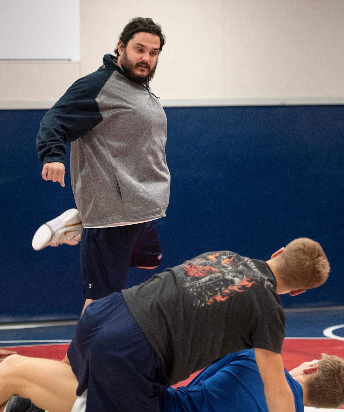 Coach John Severe talks with wrestlers during practice at Beyer High School in Modesto, Calif., on Monday, Dec. 20, 2021.