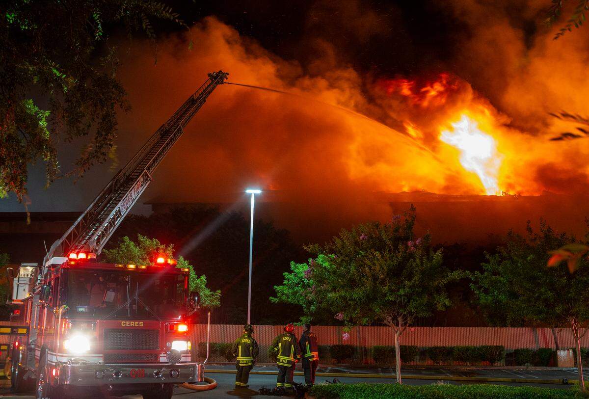 Modesto Fire Department crews battle a huge structure fire at a warehouse at the corner of Tully Road and Ninth Street on Sunday, July 7, 2019.