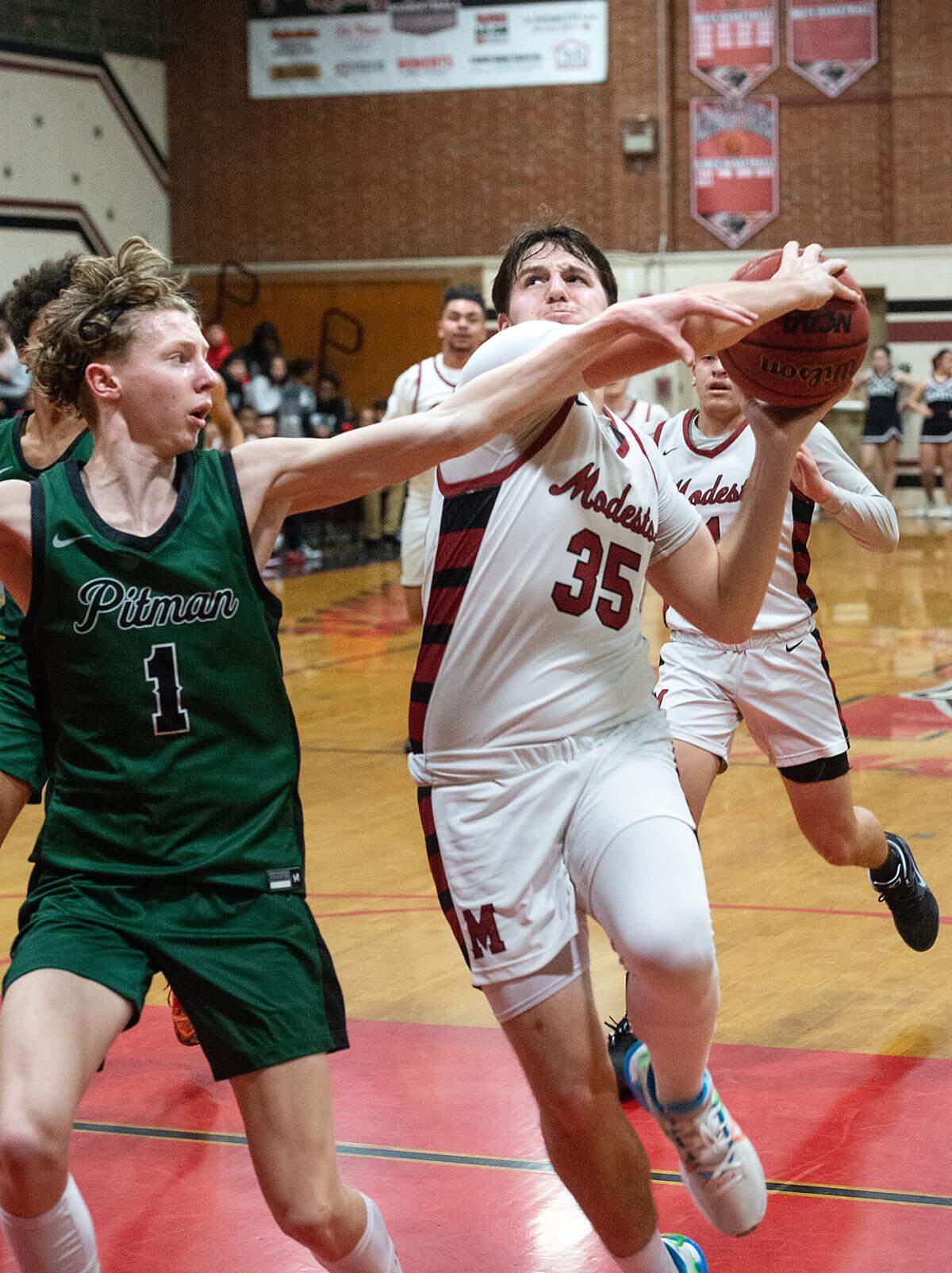 Pitman’s Avery Sanchez defends on Modesto’s Heston Blom during a Central California Athletic League game at Modesto High School in Modesto, Calif., Friday, Jan. 13, 2023. Pitman won the game 70-46.