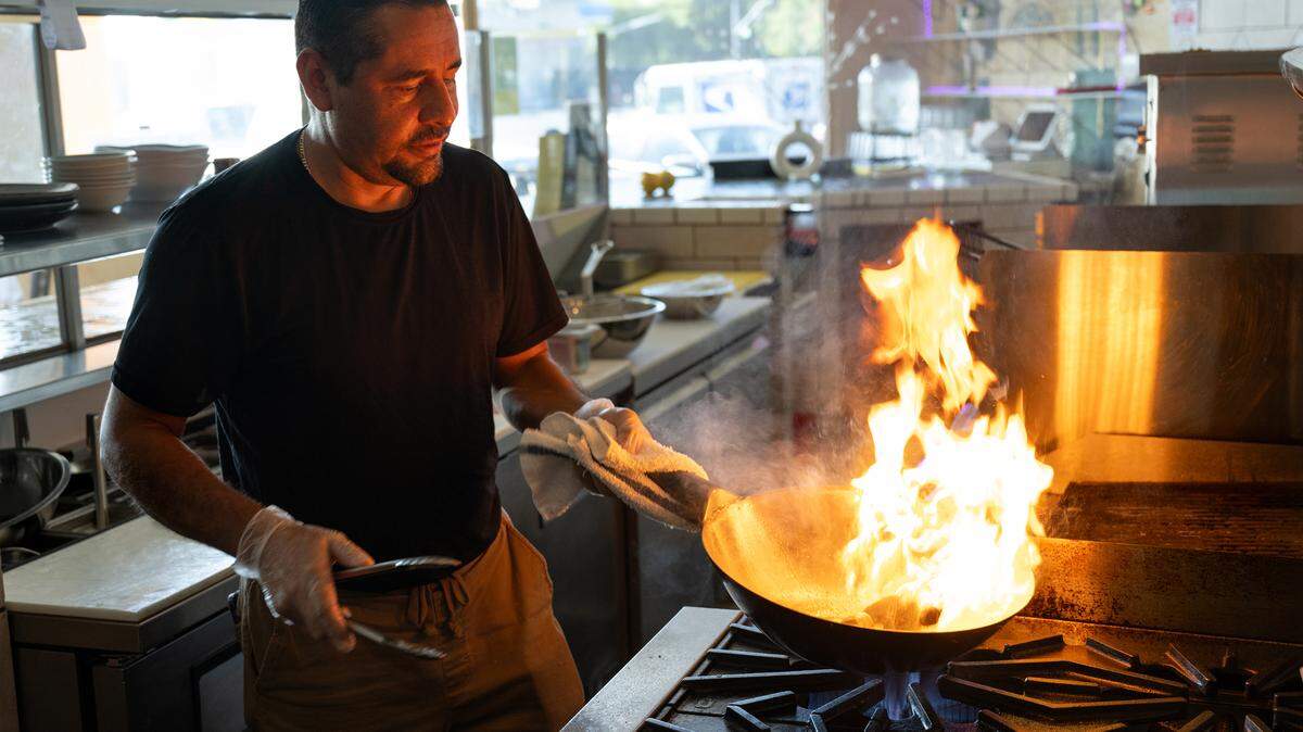 Chef and co-owner Abel Casillas prepares lomo saltado at Las Uvas Restaurant in Modesto, Calif., Thursday, Oct. 5, 2023. 