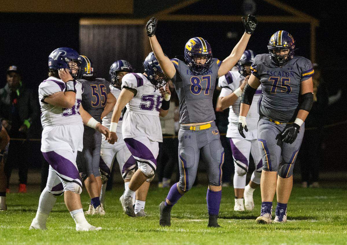 Escalon’s Ryan Lewis celebrates a touchdown by teammate Talan Reider during the first round playoff game with Pacheco in Escalon, Calif., Friday, Nov. 4, 2022.