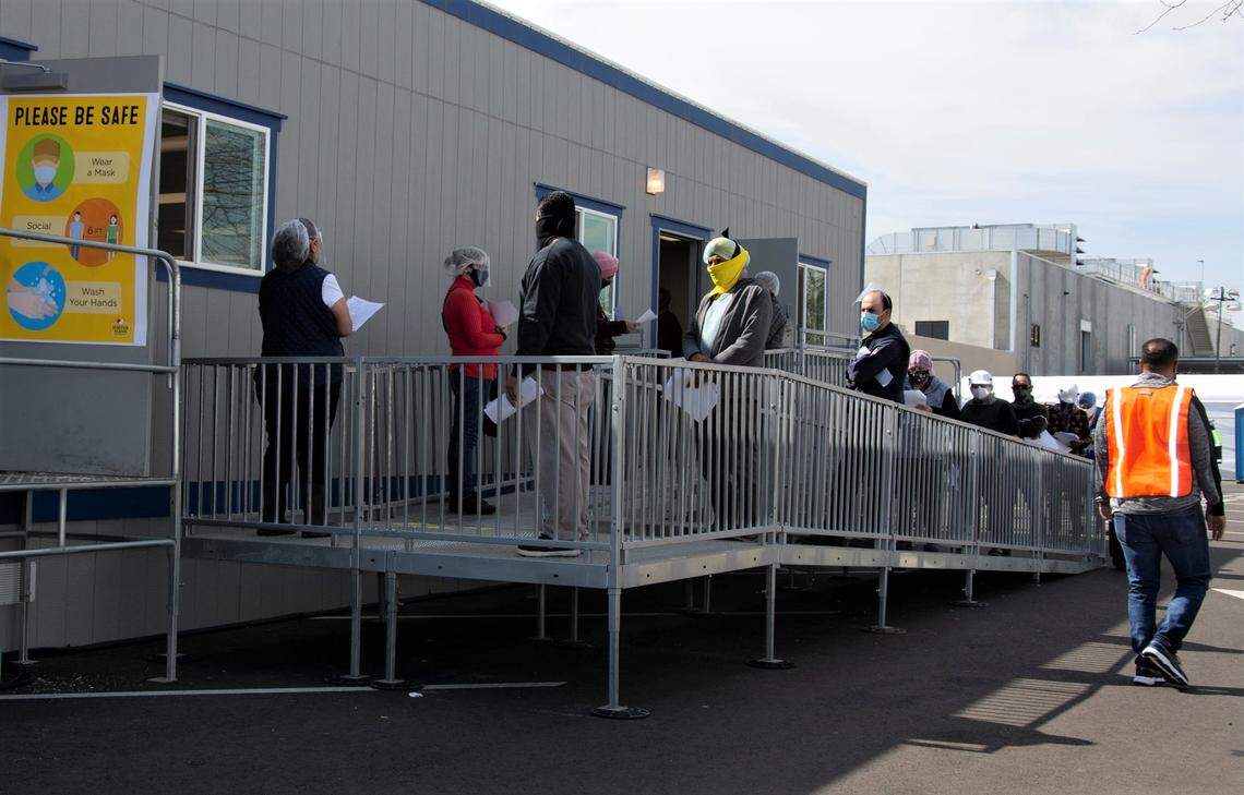 Foster Farms employees waits to receive their COVID-19 vaccine at the plant in Livingston, Calif. March 2, 2021.