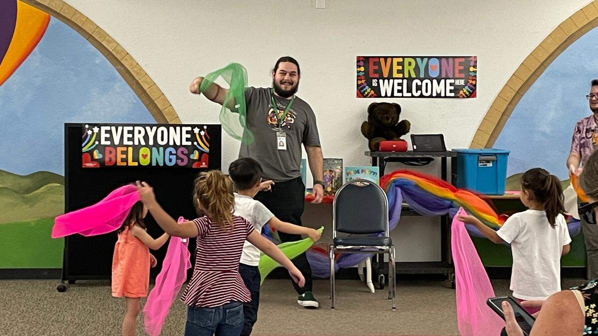 Library assistant Teddy Snyder leads children in a scarf dance during Rainbow Story Time in Salida on June 15, 2023.