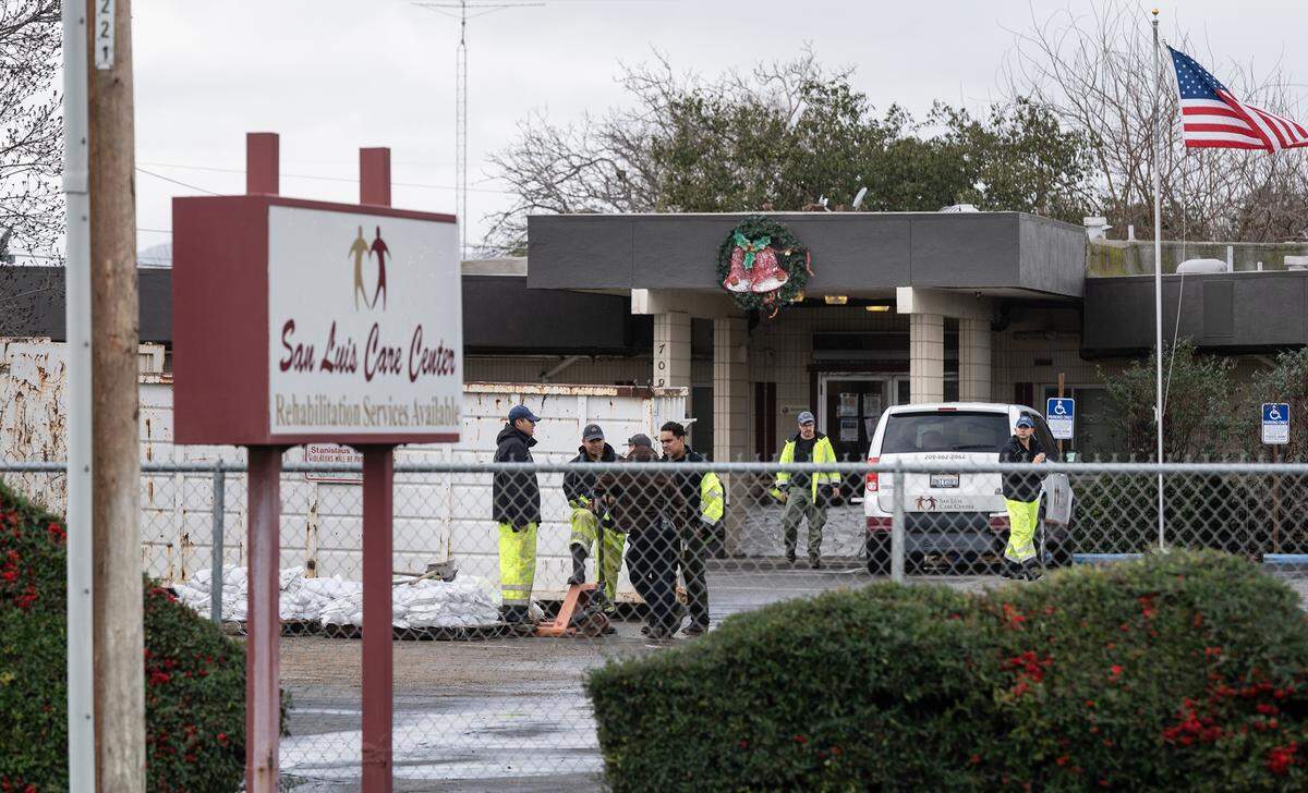 A crew had just finished securing the doorways with sandbags at San Luis Care Center in Newman, Calif., Tuesday, Jan. 10, 2023. The center was evacuated Monday due to anticipated flooding.