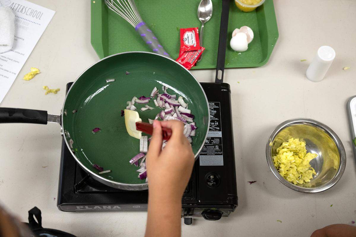 Ella Hernandez sautés red onion during the Junior Chef after school program at Sipherd Elementary School in Modesto, Calif., Thursday, Sept. 19, 2024.