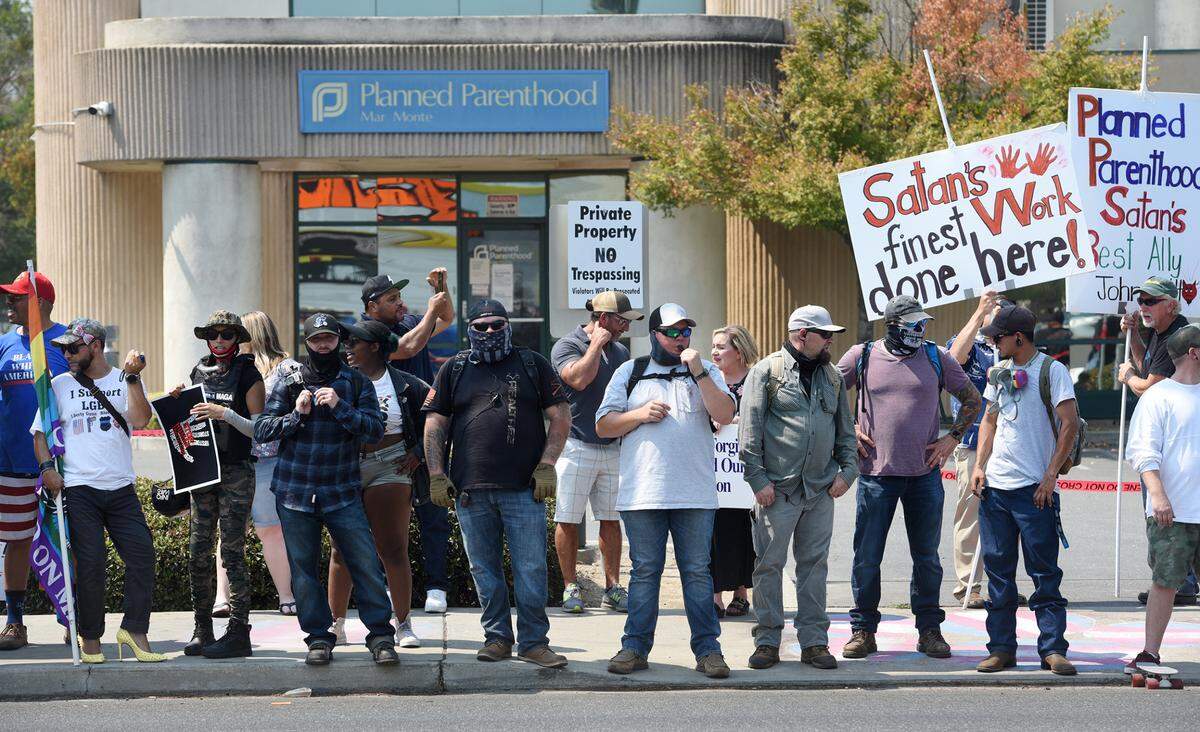 Participants stand outside the Planned Parenthood office on McHenry Avenue during a straight pride rally that brought militia members and the Proud Boys to Modesto, Calif., on Saturday August 29, 2020.