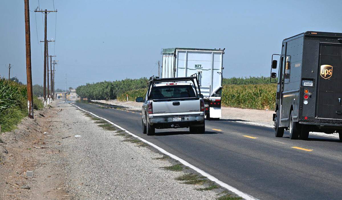 A motorist passes two vehicles on Shiloh Road near Grayson, Calif., on Tuesday, August 30, 2022.