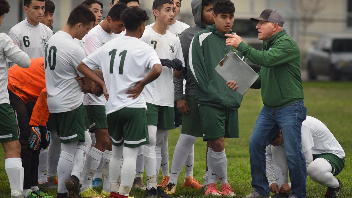 Hilmar High school’s soccer coach Louie Bettencourt (right) talks to his team during a timeout in a match against Escalon High Thursday January 10, 2019 in Escalon, Calif.