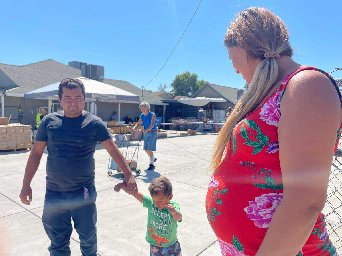 Jose Villalobo Mendoza and Griselda Madriz Pulido play with their son by the Rock Church. Madriz Pulido is 6 months pregnant.