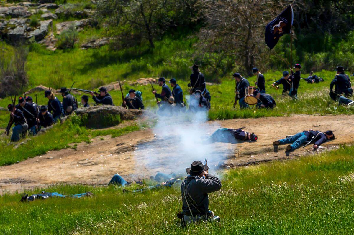A Confederate soldier fires on a Union line during a Civil War reenactment in Knights Ferry, Calif. east of Modesto the weekend of March 25 and 26, 2023.