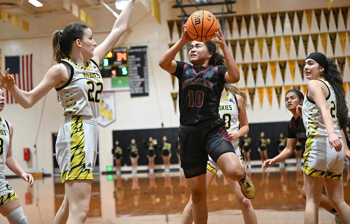 Riverbank’s Chancis Gamez attacks the basket as Hughson’s Jasmin Richardson defends during the Trans Valley League game with Riverbank at Hughson High School in Hughson, Calif., Thursday, Feb. 1, 2024.