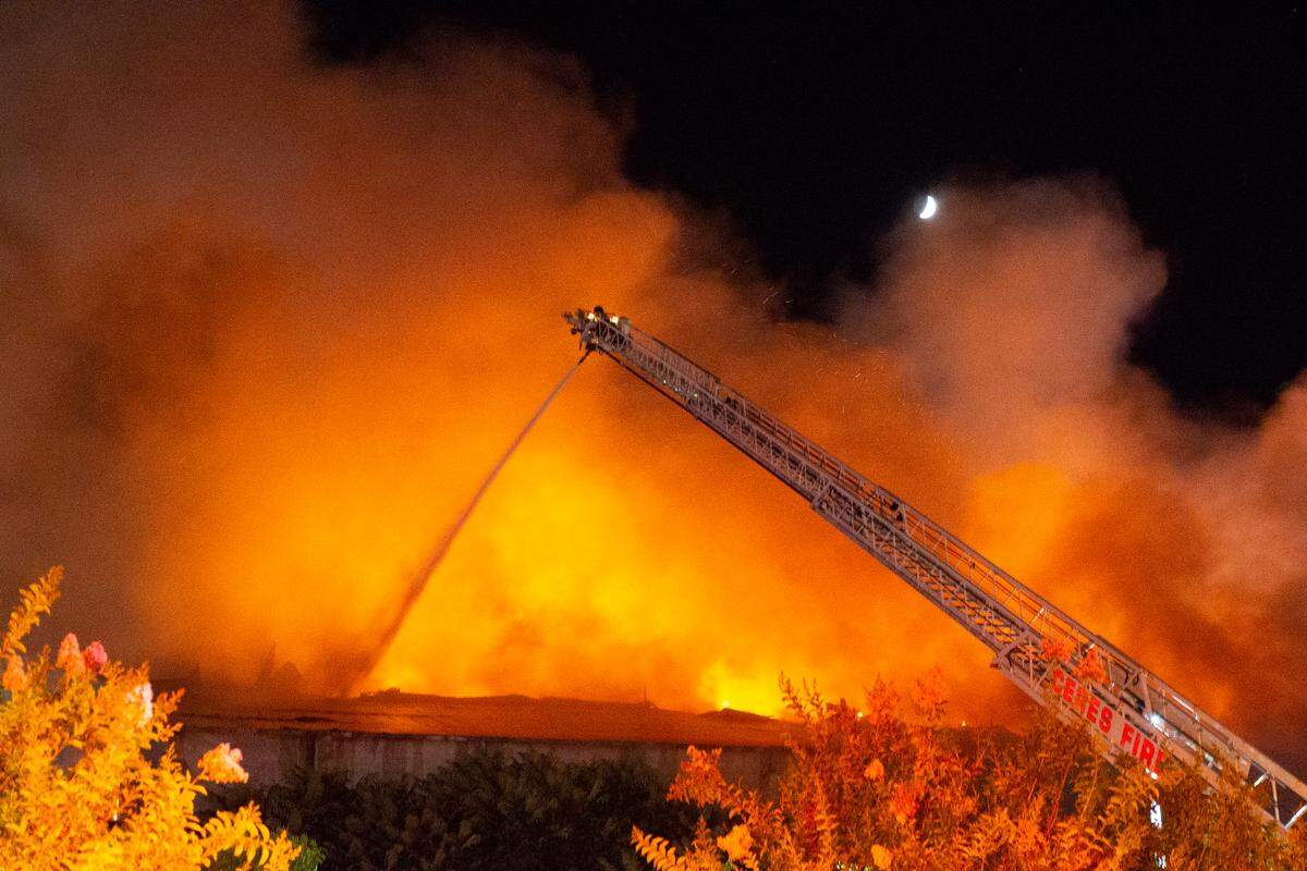 Modesto Fire Department crews battle a huge structure fire at a warehouse at the corner of Tully Road and Ninth Street on Sunday, July 7, 2019.