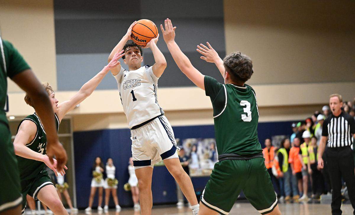 Central Catholic’s Jordan Magana shoots a jump shot over Manteca’s L.J Legan (3) and Peyton Nieman (23) during the Valley Oak League game at Central Catholic High School in Modesto, Calif., Wednesday, Feb. 7, 2024. Central Catholic won the game 57-51.