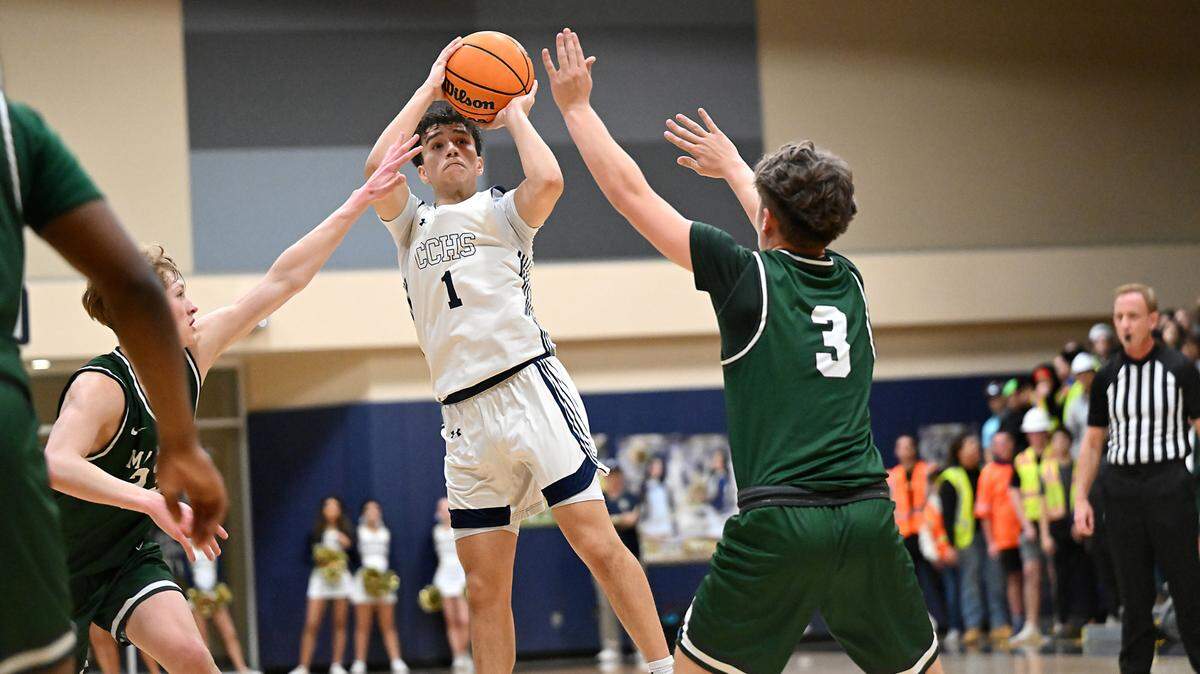 Central Catholic’s Jordan Magana shoots a jump shot over Manteca’s L.J Legan (3) and Peyton Nieman (23) during the Valley Oak League game at Central Catholic High School in Modesto, Calif., Wednesday, Feb. 7, 2024. Central Catholic won the game 57-51.