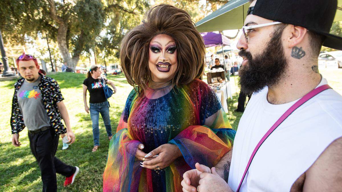 MC Sasha Devaroe, middle, and her husband Larry Soria, right, attend the MoPride festival at Graceada Park in Modesto, Calif., Saturday, Oct. 1, 2022.