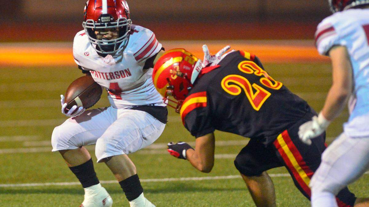 Patterson running back Sean Hansen (4) tries to cut back during a CIF Sac-Joaquin Division III playoff game between Oakdale and Patterson highs at Oakdale High School in Oakdale, California, on Nov. 19, 2021.