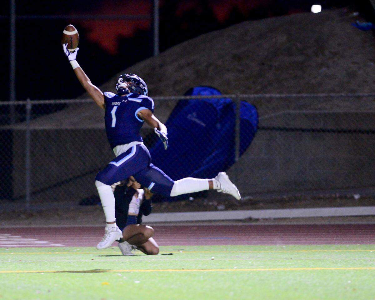 Downey receiver Nathan Dip tries to make a catch during a game between Downey High School and Merced High School at Downey High School in Modesto California on September 1, 2023.