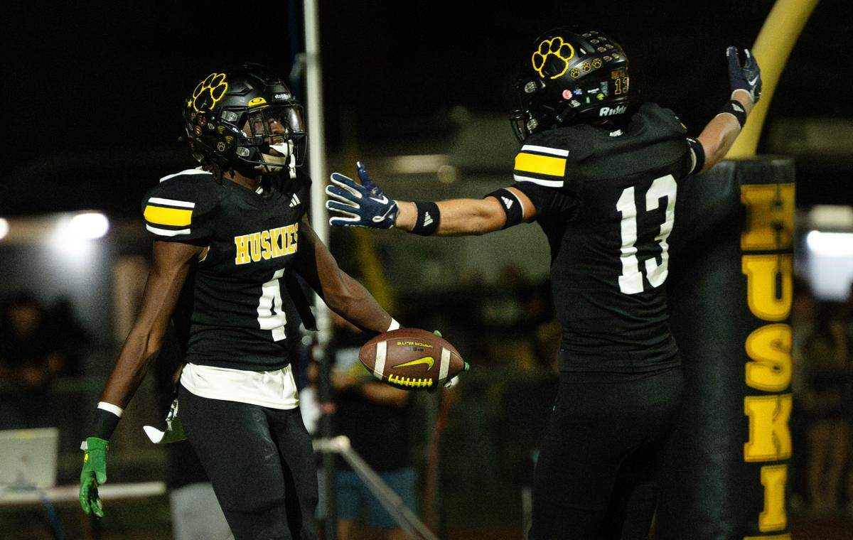 Hughson’s Malakai Sumter, left, celebrates a touchdown with Bryce McDaniel during the Trans Valley League game with Escalon in Hughson, Calif., Friday, Oct. 4, 2024.
