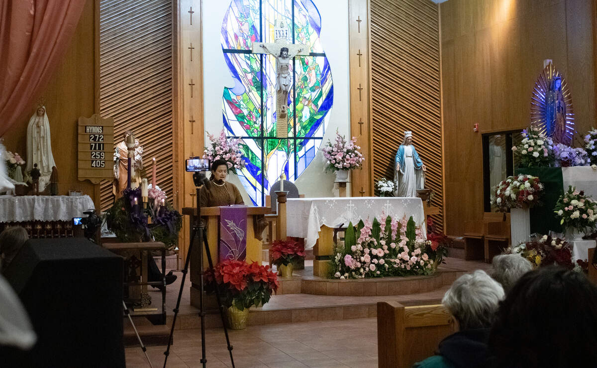 Isela Velasco translates English visiting speakers’ words for Spanish-speaking parishoners at the “Silence is Complicity” interfaith vigil at St. Francis of Rome Catholic Church in Riverbank on Dec. 13.