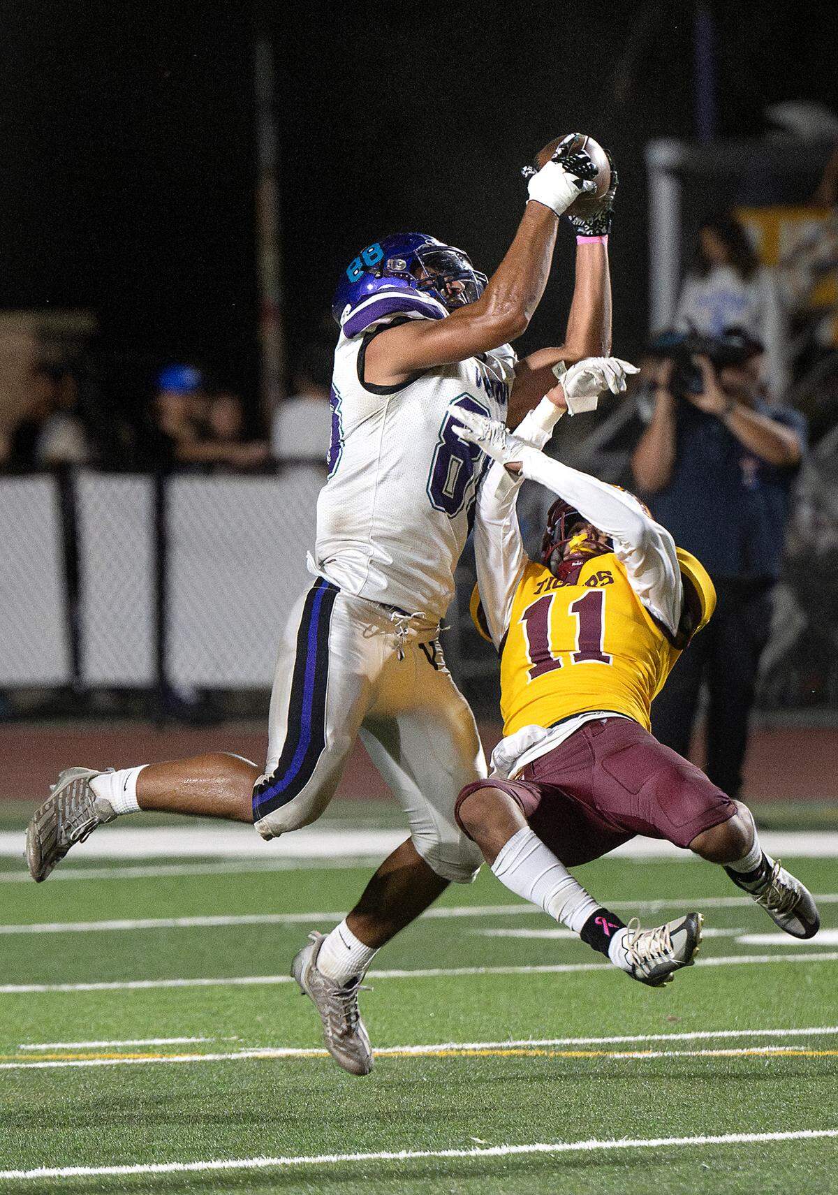 Johansen’s Anthony Alves makes a catch over a Los Banos defender during the Western Athletic Conference game at Johansen High School in Modesto, Calif., Friday, Oct. 6, 2023.