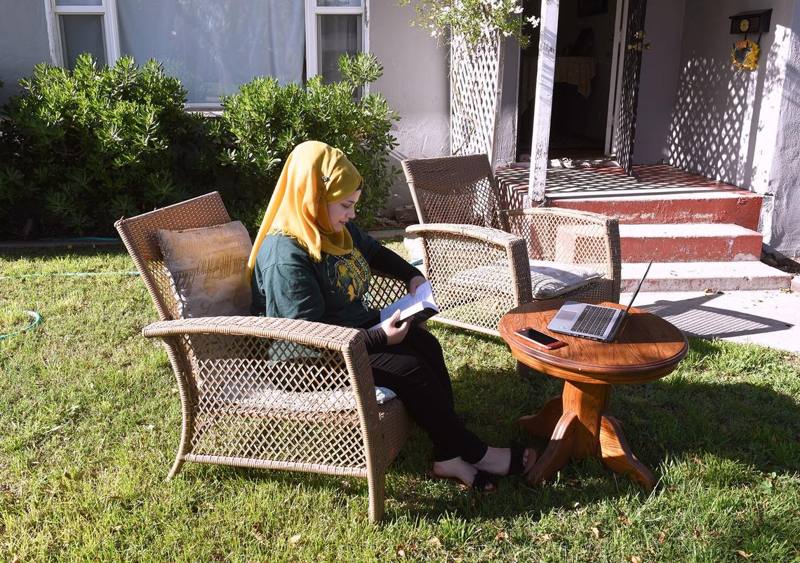 Ayat Alfares, a student at Davis High School, studies at her Modesto home on Tuesday April 24, 2018. Language Institute students who are turning 18 may be sent to adult school in a change in school district policy that previously gave extra time in high school to refugee students.