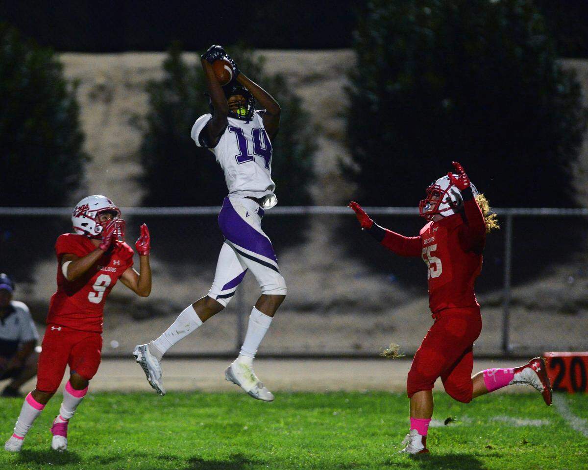 Pacheco running back Deyonte Bell (14) leaps to make a catch over the middle during a game between Ceres High School and Pacheco High School at Ceres High School in Ceres California on October 7, 2022.