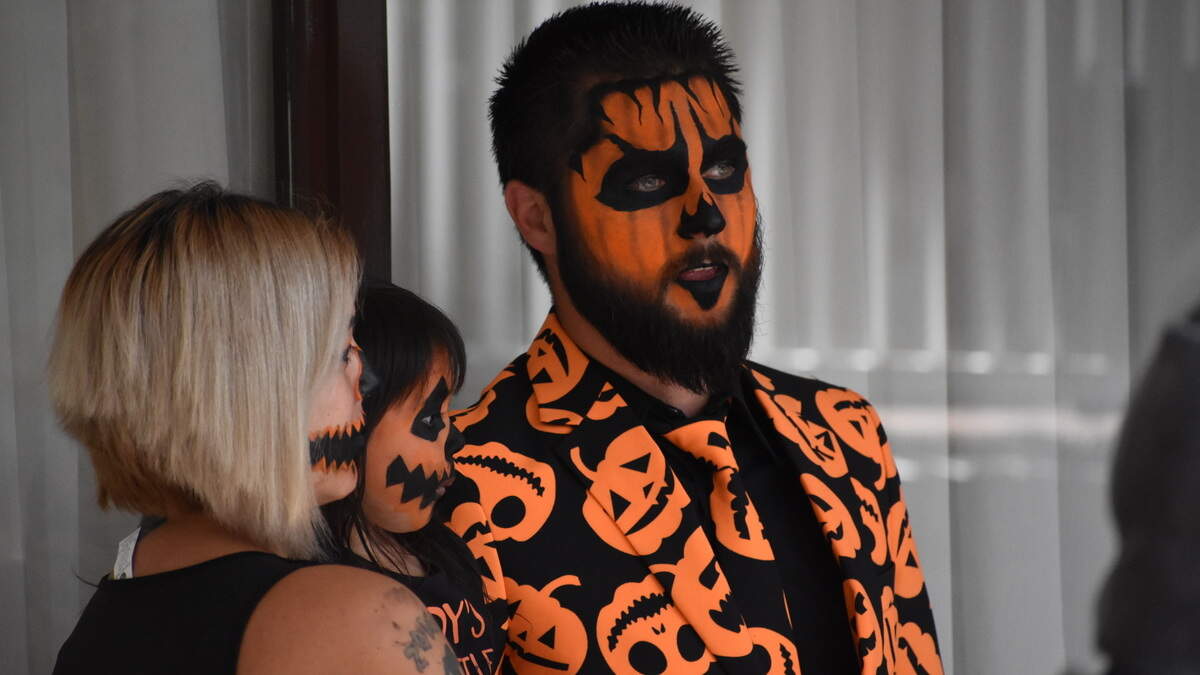 David S. Pumpkins  has a cousin?  A family waits its turn during the costume contest at Spooky Con at the Clarion Inn in Modesto on Sunday, Oct. 14. 2018.