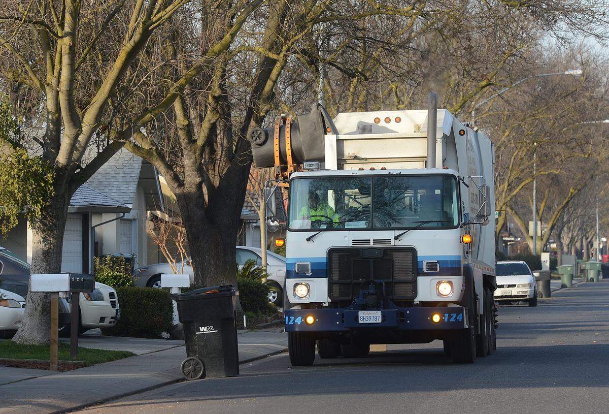 A Gilton Solid Waste Management truck picks up garbage on Dorset Lane near Pridmore Avenue in Modesto in 2013.