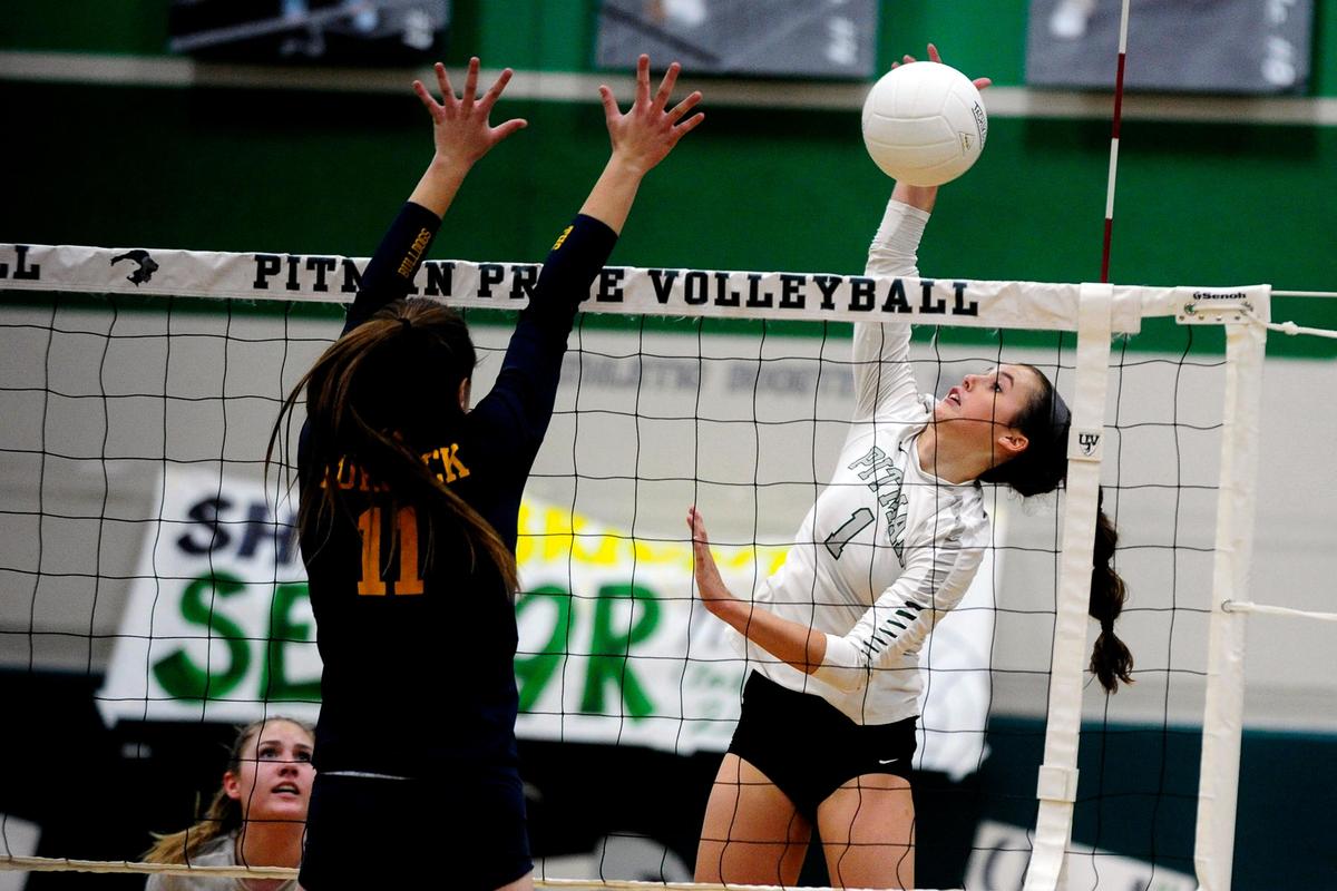 Turlock’s Beth Johnson (11) goes to block as Pitman’s Cierra Verdone (1) spikes the ball, during the senior night, crosstown volleyball matchup of Turlock High at Pitman High, on Monday, Oct., 15 in Turlock, California.